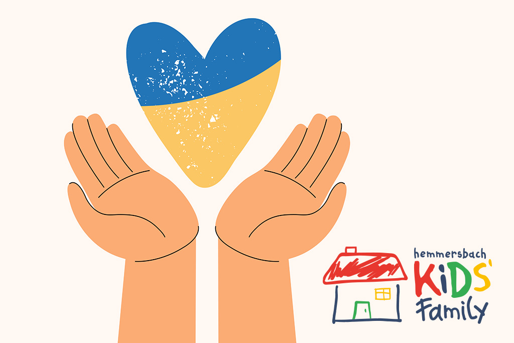 flaga ukraińska w kształcie serca, a poniżej otwarte donie i logo fundacji Hemmersbach Kids' Family
